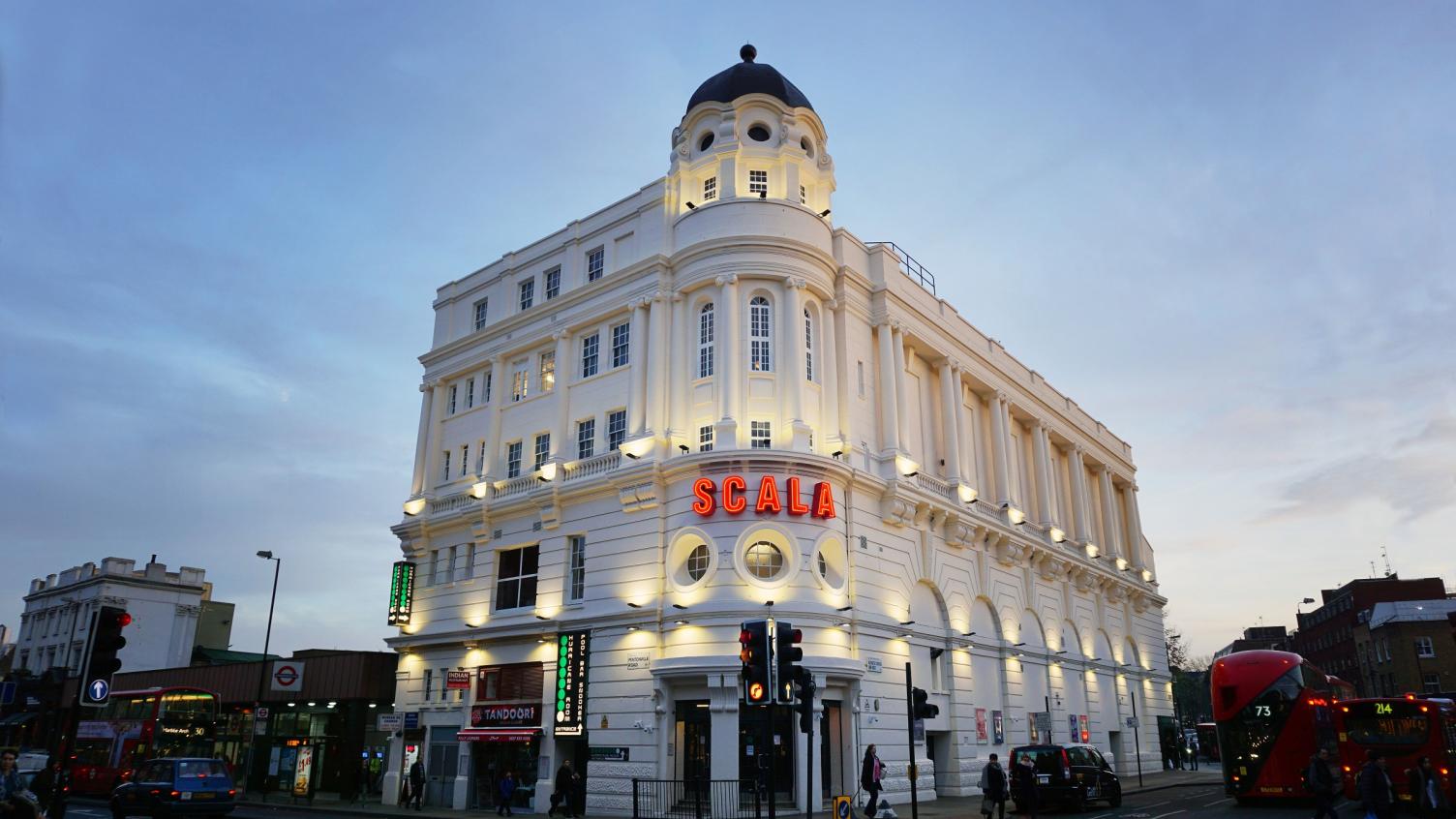 A large white building with 'Scala' on the front in bright read lettering