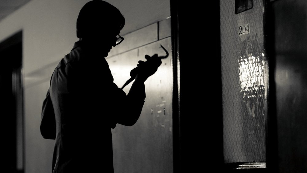 1971 2014 001 silhouette of young man with crowbar outside office door