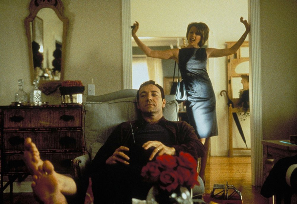 Bening as Carolyn Burnham behind Kevin Spacey as her husband Lester in American Beauty (1999)