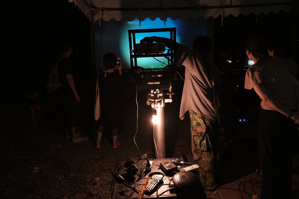 A projectionist at work at the Udon Thani Animistic Apparatus show