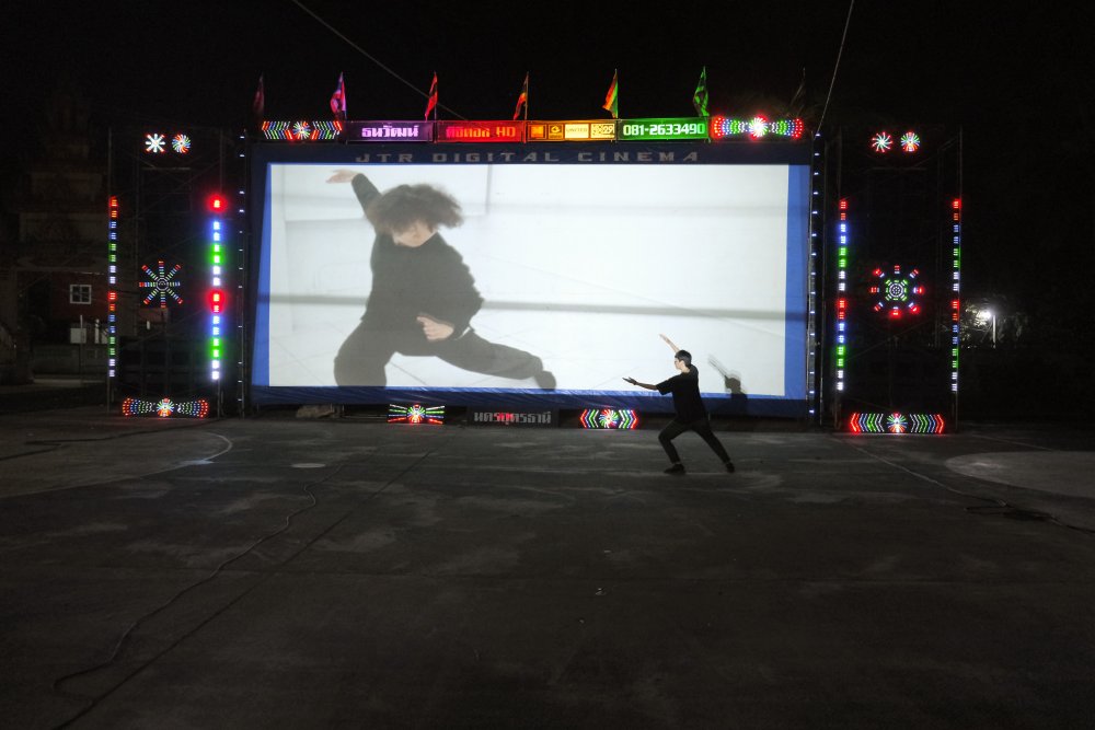 An Animistic Apparatus ballet in front of a screen in Udon Thani, Thailand