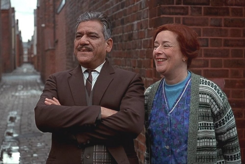 As George Khan with Linda Bassett in East Is East (1999)