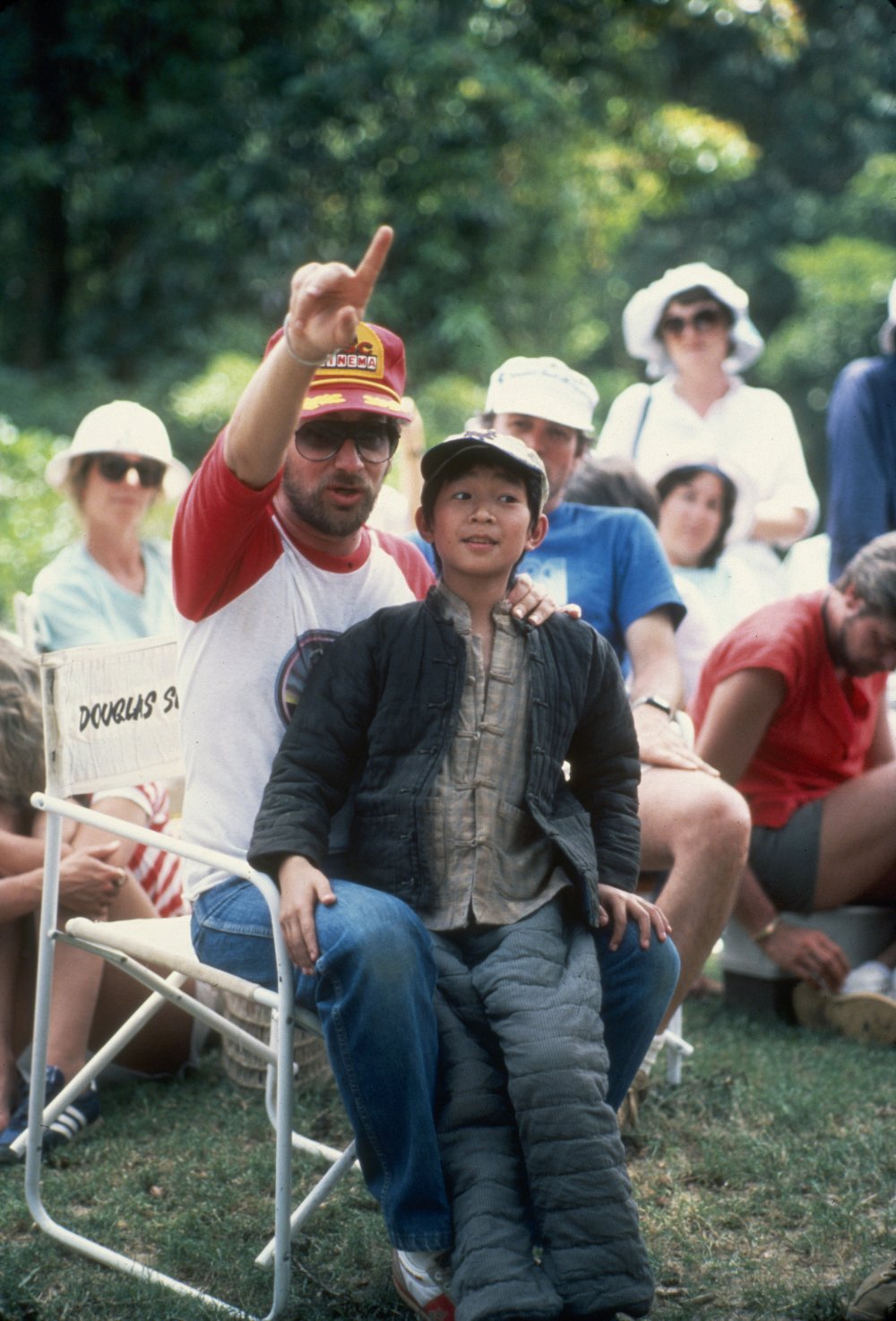 In cinematographer Douglas Slocombe&amp;#8217;s chair, Spielberg enjoys a moment in between takes with 12-year-old actor Ke Huy Quan (who plays Indy&amp;#8217;s sidekick Short Round) on location in India for the second film in the series, Indiana Jones and the Temple of Doom (1984)