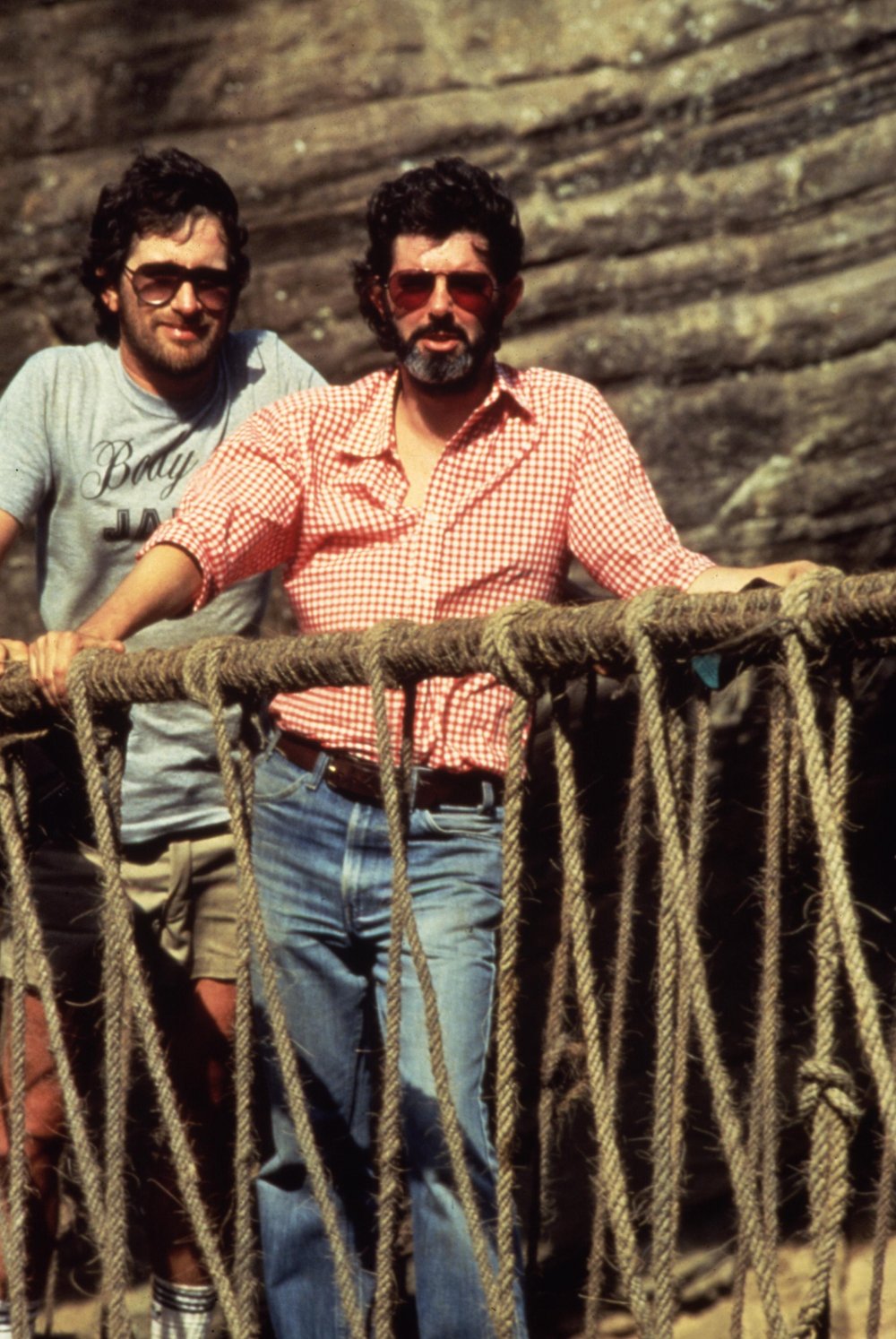 Spielberg and writer-producer George Lucas tread the treacherous rope bridge used in the finale of Indiana Jones and the Temple. The rope bridge set was constructed at Elstree Studios in Hertfordshire