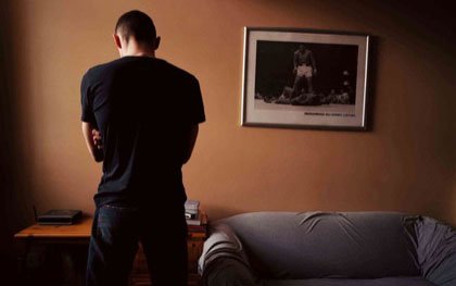 Mark, an ex-soldier who served in Iraq, photographed in his hostel room in Richmond, Yorkshire 2005.