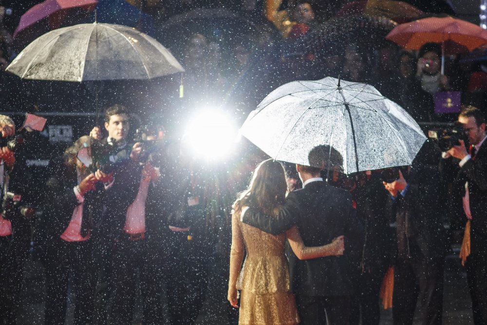 A magical shot of Imitation Game stars Keira Knightley and Benedict Cumberbatch together in the rain