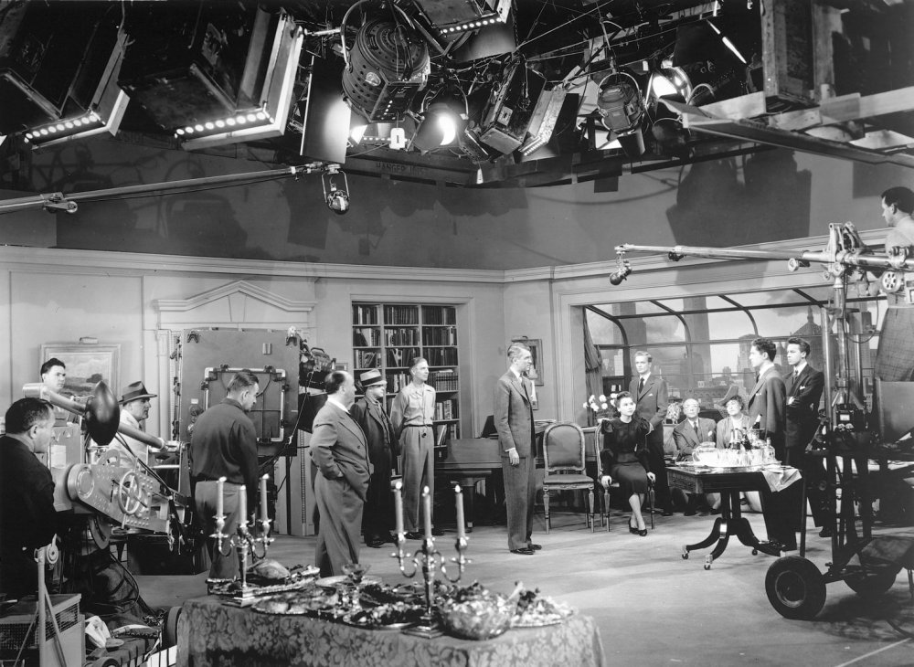 Alfred Hitchcock (to the right of the camera) with crew and cast on the set of Rope (1948)