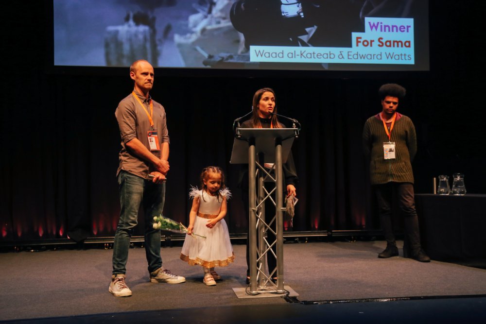 Edward Watts, Sama and Waad al-Kateab accepting Grand Jury’s Special Mention for For Sama at Sheffield Doc/Fest 2019