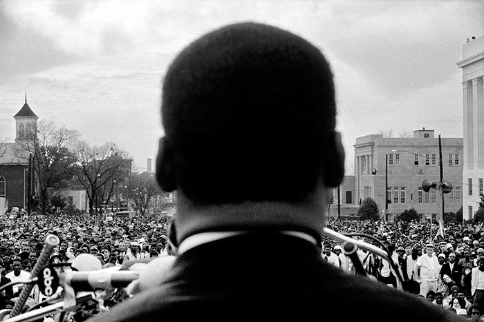 Dr. Martin Luther King, Jr. looks out at crowd in Montgomery, 1965