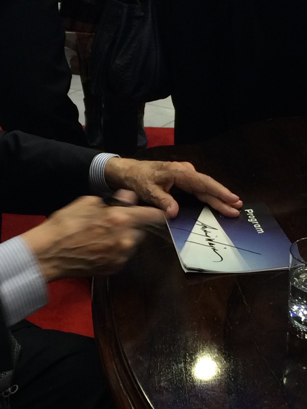 Andrzej Wajda writing his signature